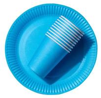 Round disposable blue paper plates and cups for a picnic, recyclable waste, top view. photo