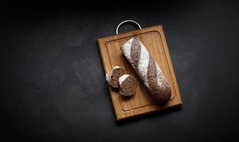 Bread on a wooden cutting board photo