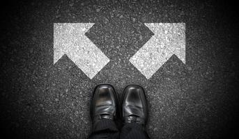 Black Business Shoes and Two Right and Left Chalky Arrows on Asphalt - Choice Concept photo