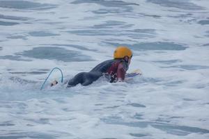 Surfers riding small ocean waves photo