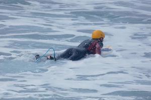 young athletes practising the water sport of surfing photo