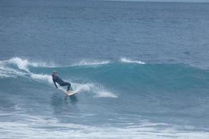 Surfers riding small ocean waves photo
