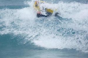 Surfers riding small ocean waves photo