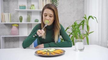 Not eating vegetables.  Unhealthy life. Young woman does not eat vegetables, does not want to eat. video