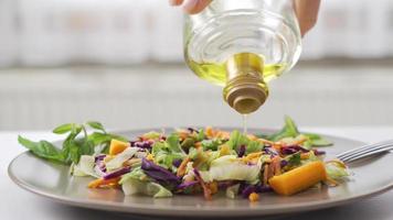 Healthy lifestyle. Pouring olive oil on the salad. Pouring olive oil on the salad. Eating healthy. video