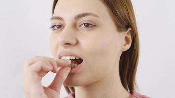 Close-up of woman eating sunflower seeds. The woman is eating seeds. video