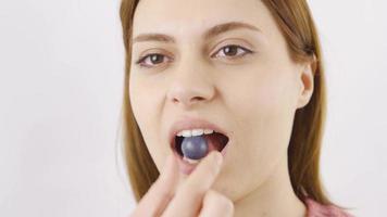 Woman eating chocolate dragee in close-up. Chocolate. Close-up woman eats chocolate balls. video