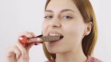 närbild av kvinna äter rån. äter choklad. närbild av kvinna äter rån. video