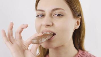 Dessert food. Close-up portrait of woman eating chocolate. Close-up portrait of woman eating chocolate. video