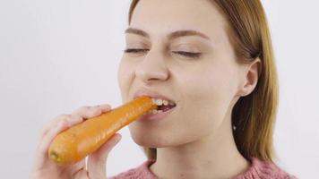 Close-up portrait of woman eating carrot. Eating vegetables. Close-up of woman eating carrot. video