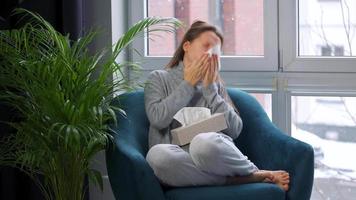 Unhealthy woman sits in a chair and coughs because she has a cold, flu video