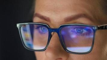 mujer en lentes mirando en el monitor y surf Internet a noche video