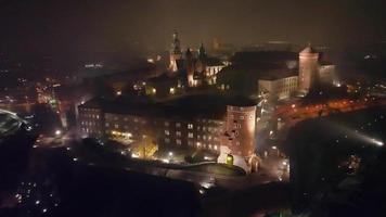 Aerial View of Wawel Royal Castle in Krakow, Poland at foggy night.