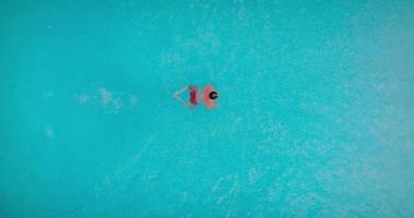 Aerial view as a man dives into the pool and swims video