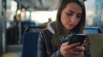 Public transport. Woman in glasses using smartphone video