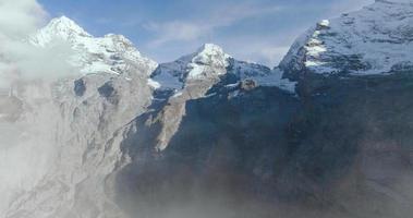 Aerial view of the rocky peaks of Swiss Alps with clouds video