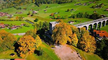 Aerial view of the beautiful Swiss nature with railroad bridge and village video