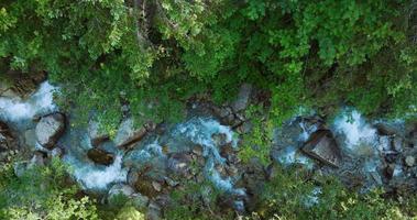 Top down view a mountain river flowing among large stones video