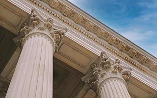 Classic architectural column. Details of architecture of historical construction. Element of exterior building with columns and Stucco molding on ceiling of architectural structure in London, UK. photo