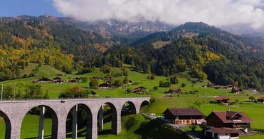 Aerial view of the beautiful Swiss nature with railroad bridge and village video