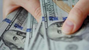 Female hand dressed man counting US Dollar bills, close-up. video