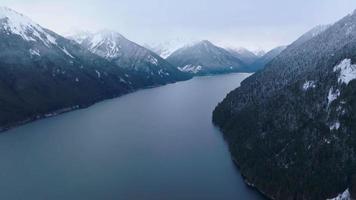 Aerial landscape view of Chilliwack Lake and mountains in winter. video