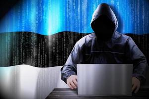 Anonymous Hooded Hacker and Flag Of Estonia, Binary Code - Cyber Attack Concept photo