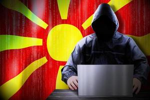 Anonymous Hooded Hacker and Flag Of Macedonia, Binary Code - Cyber Attack Concept photo