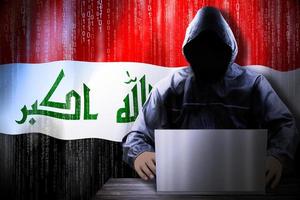 Anonymous Hooded Hacker and Flag Of Iraq, Binary Code - Cyber Attack Concept photo