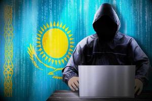 Anonymous Hooded Hacker and Flag Of Kazakhstan, Binary Code - Cyber Attack Concept photo