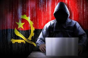 Anonymous Hooded Hacker and Flag Of Angola, Binary Code - Cyber Attack Concept photo