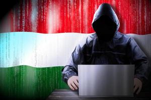 Anonymous Hooded Hacker and Flag Of Hungary, Binary Code - Cyber Attack Concept photo