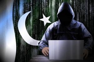 Anonymous Hooded Hacker and Flag Of Pakistan, Binary Code - Cyber Attack Concept photo