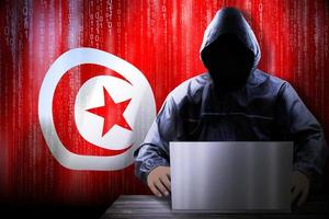 Anonymous Hooded Hacker and Flag Of Tunisia, Binary Code - Cyber Attack Concept photo