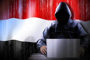 Anonymous Hooded Hacker and Flag Of Yemen, Binary Code - Cyber Attack Concept photo