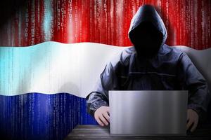 Anonymous Hooded Hacker and Flag Of Netherlands, Binary Code - Cyber Attack Concept photo