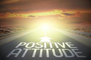 Positive attitude word on a road and sunset sky photo