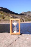Hourglass on the rock photo