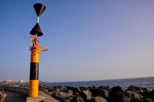 Buoy beacon on the shore photo