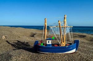 Toy ship in the sand photo