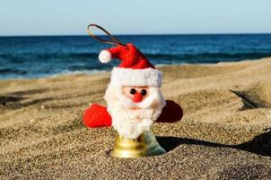 Santa ornament in the sand photo