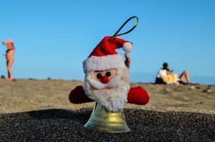 Santa bell in the sand photo