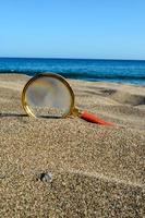 Magnifier in the sand photo