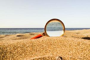 Magnifier in the sand photo
