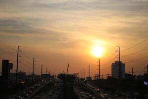 bright golden cloudy sky in sunset background in city building town photo