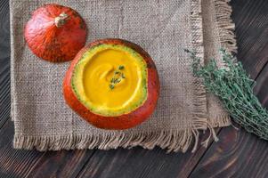 Pumpkin soup served in hokkaido pumpkin photo