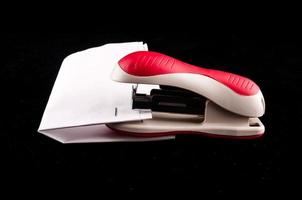 Stapler on dark background photo