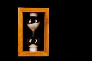 Hourglass on dark background photo