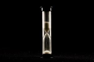 Hourglass on dark background photo