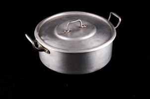 Metal pot on dark background photo